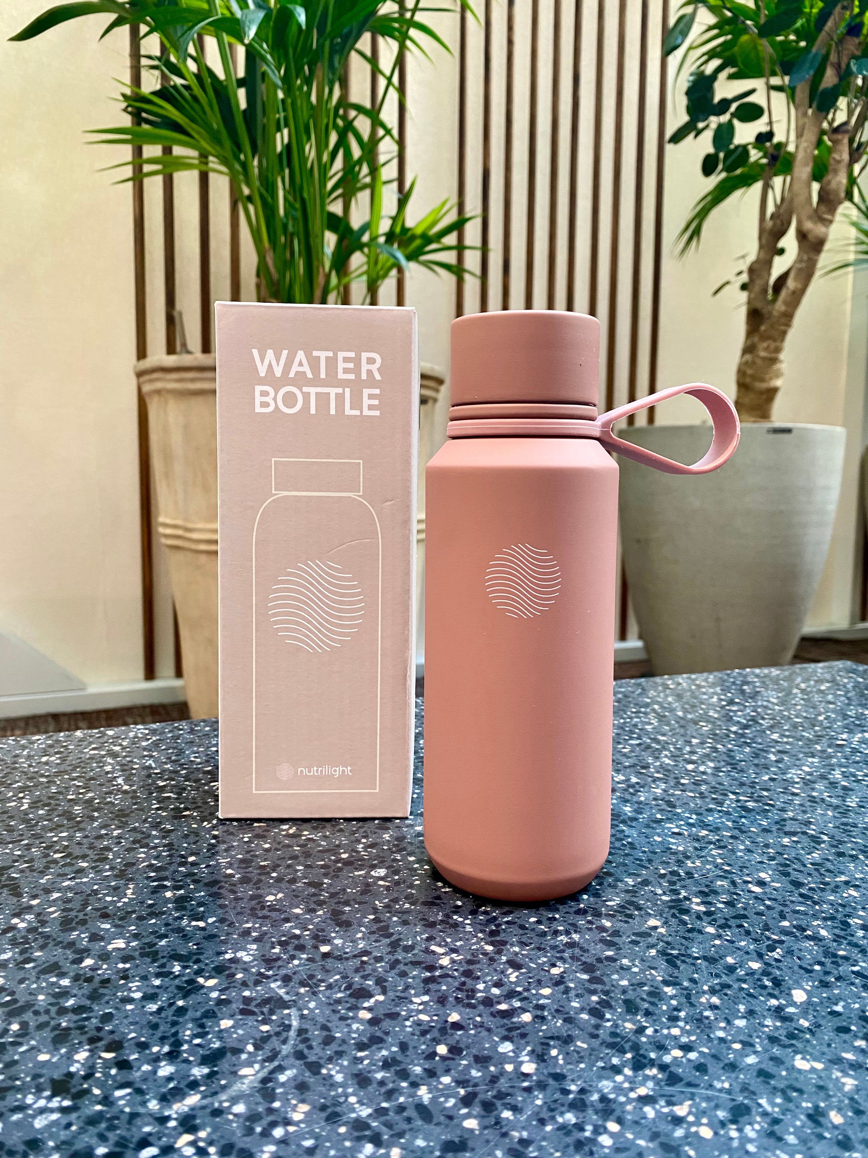 Pink waterbottle on a table