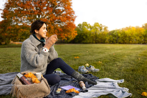 A woman in autumn wearing a red light therapy bracelet